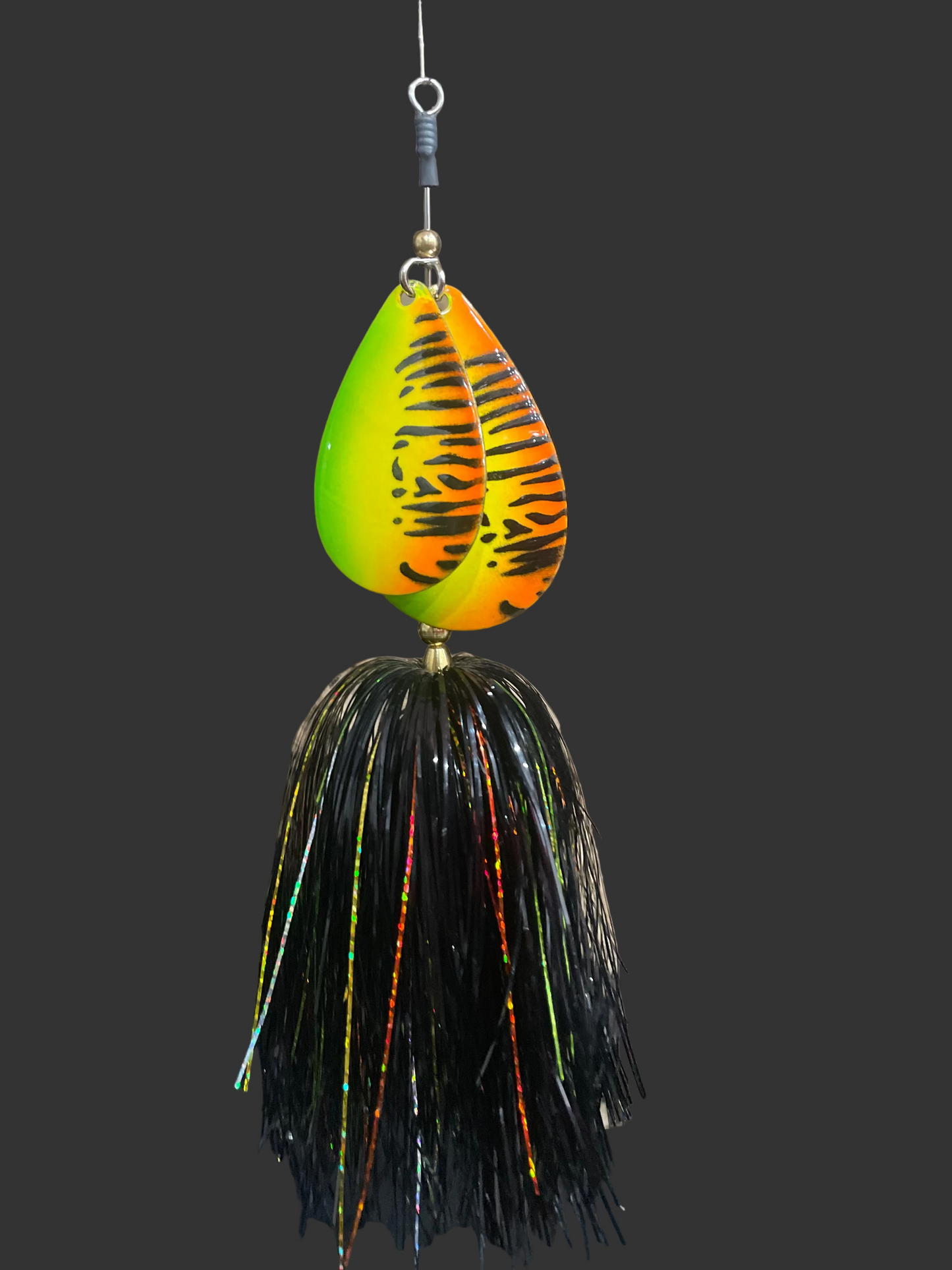 Fishing lure with tiger stripe pattern on a black background