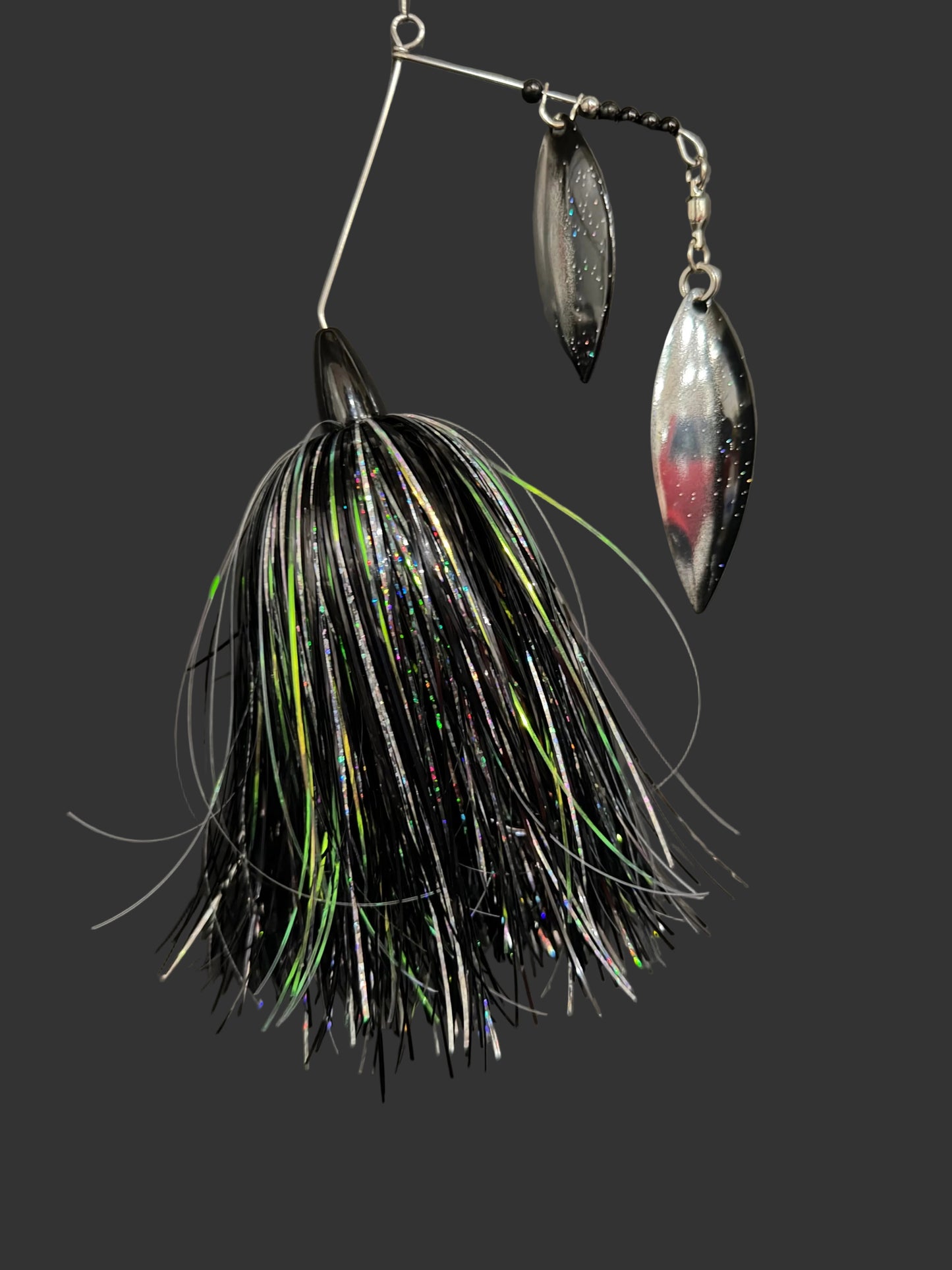 Fishing lure with black and green details on a gray background