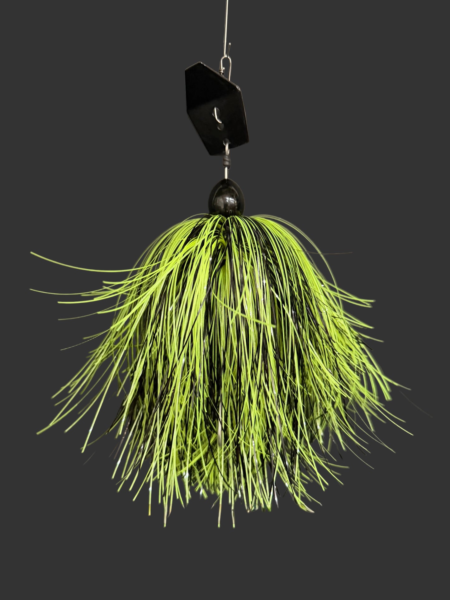 A Muskie chatterbait fishing lure with a black blade and Glow Yellow and black skirt. Made by Lure-cifer in Brantford Ontario Canada