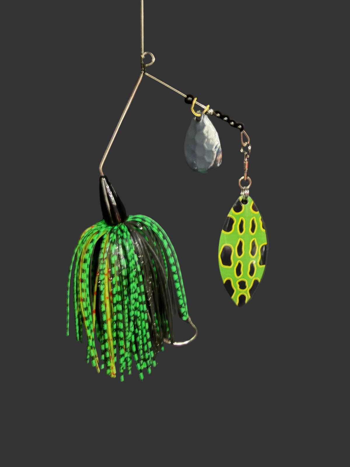 A 3/8 oz Bass Spinnerbait fishing lure featuring a #4/0 hook, #5 Willow Blade, and deep cut Colorado blade. Catch more fish with this green and black lure designed for optimal performance.