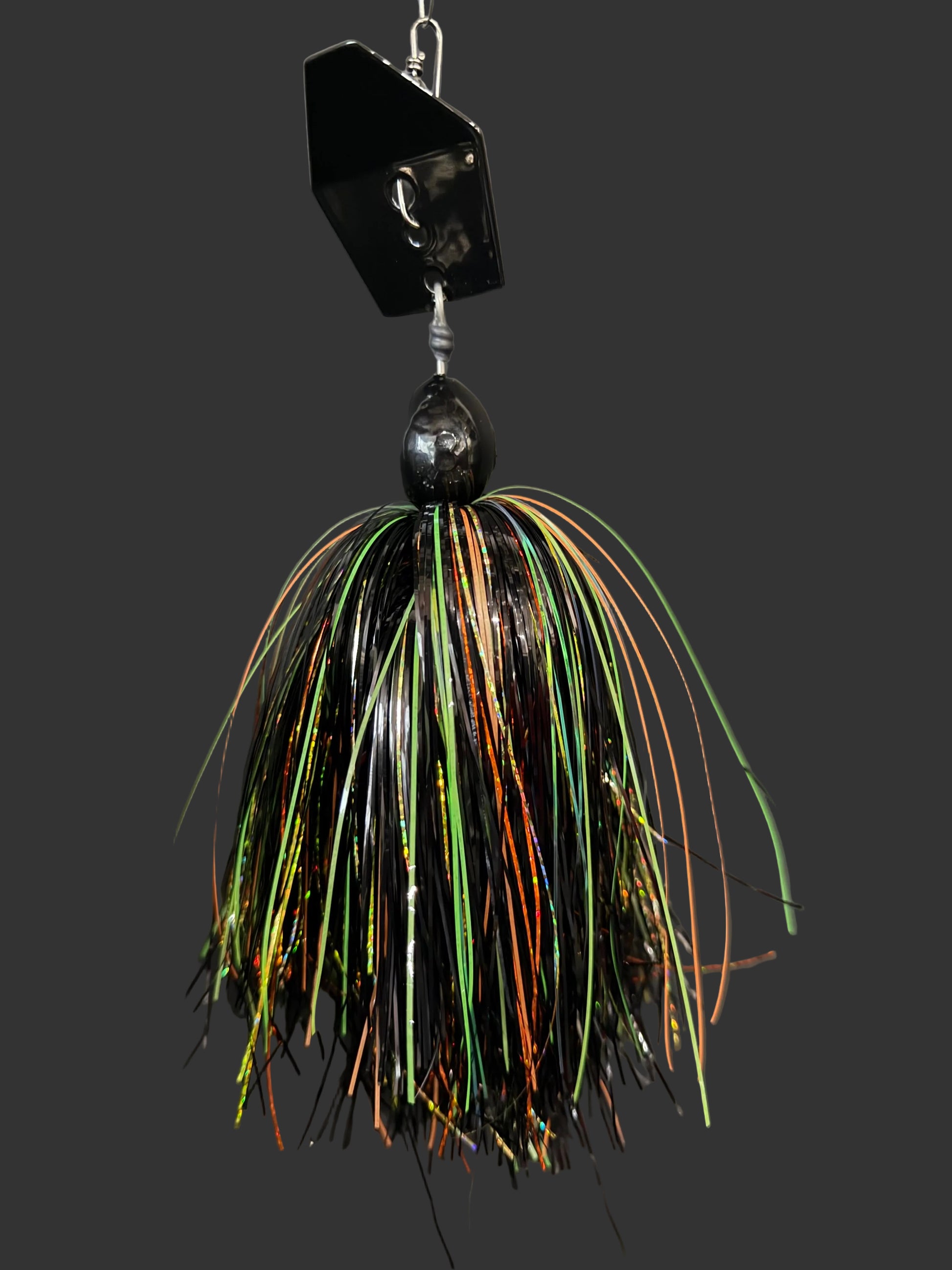Muskie chatterbait with a black blade and a fire tiger skirt that is black, orange and chartreuse. Made by Lure-cifer in Brantford, Ontario, Canada.