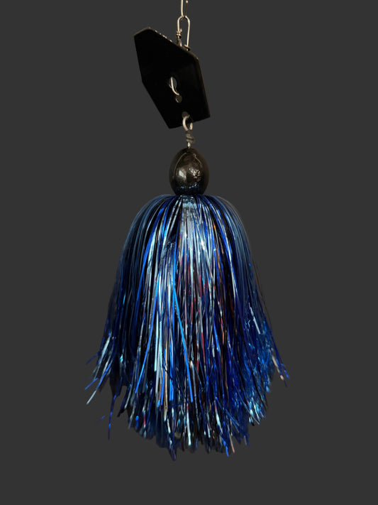A muskie fishing lure with a black blade and a blue, silver and black skirt. Made by Lure-cifer in Brantford, Ontario Canada