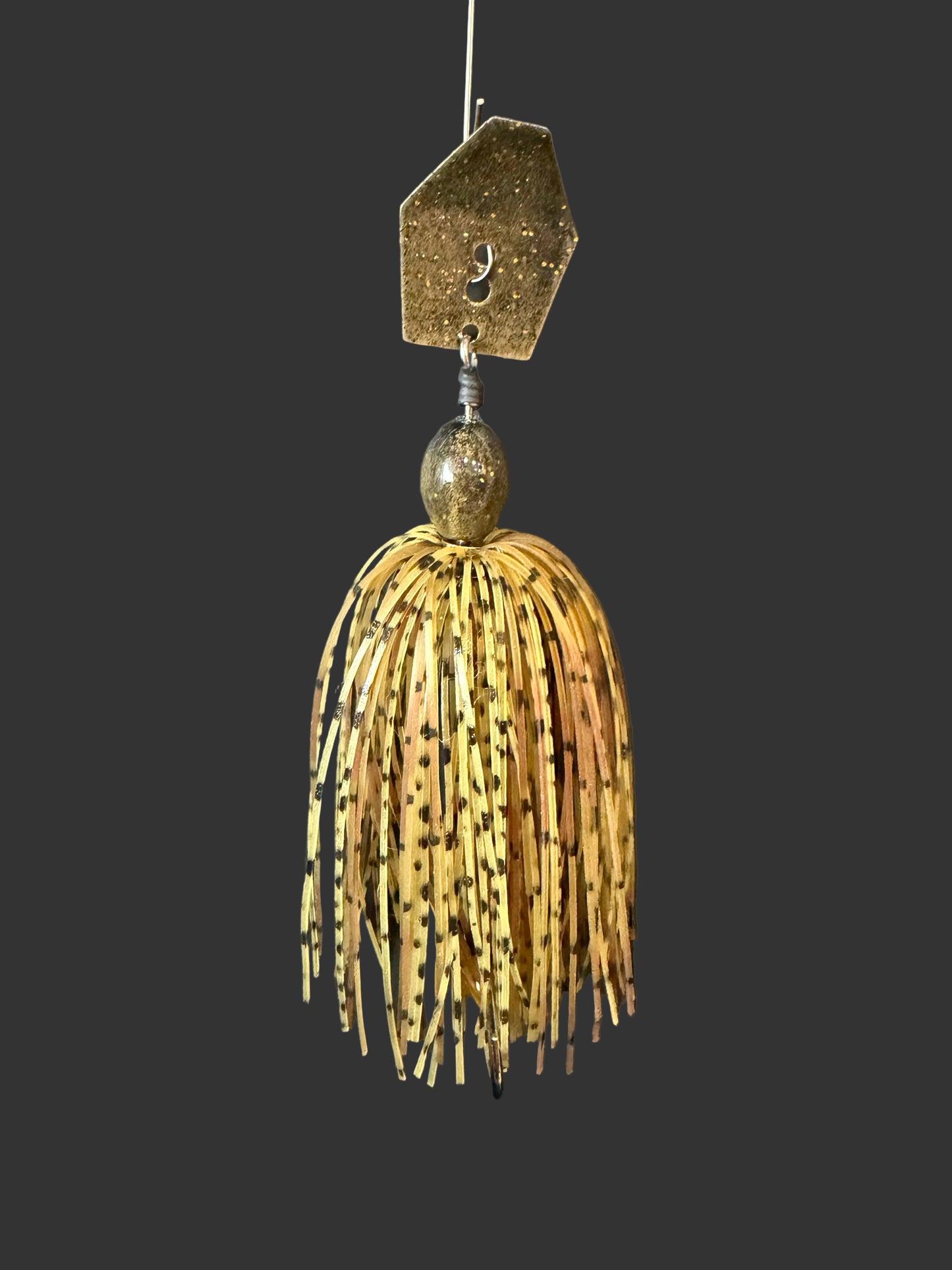 Fishing lure with a detailed head and shad body on a dark background