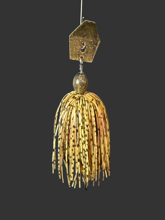 Fishing lure with a detailed head and shad body on a dark background