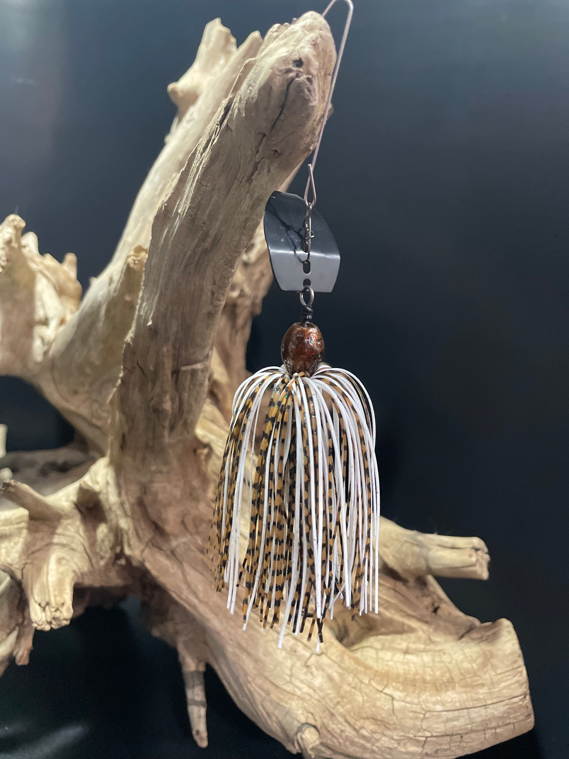 Introducing Dust Devil, the ultimate Chatterbait fishing lure for anglers. Designed with a sleek white and brown colour scheme, this 3/8 oz bait is perfect for catching a variety of fish. Its #4/0 hook and black blade ensure maximum hooking power. Upgrade your fishing game with Dust Devil.