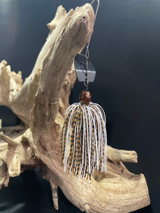 Introducing Dust Devil, the ultimate Chatterbait fishing lure for anglers. Designed with a sleek white and brown colour scheme, this 3/8 oz bait is perfect for catching a variety of fish. Its #4/0 hook and black blade ensure maximum hooking power. Upgrade your fishing game with Dust Devil.