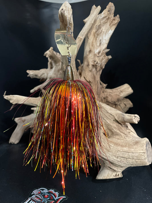 Fishing lure with multicolored tinsel on a dark background