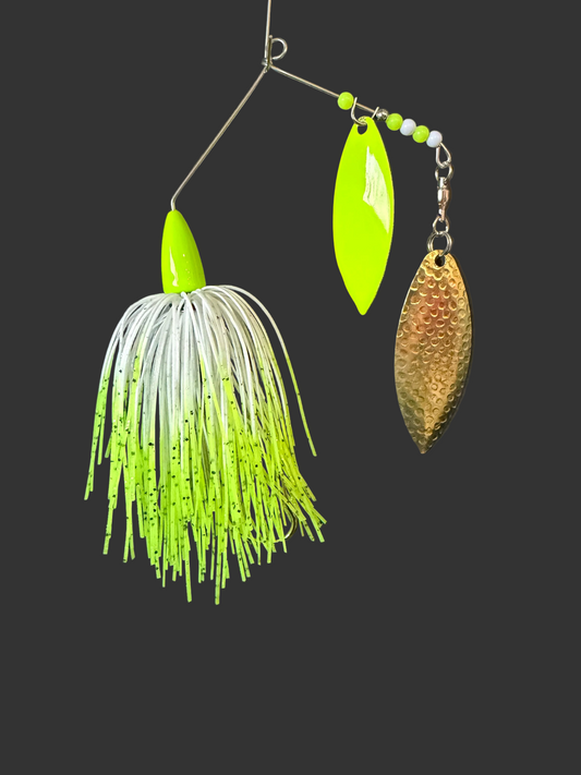 Fishing lure with green and gold details on a black background