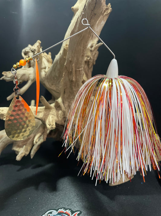 The Golden Heretic is an expertly crafted Spinnerbait made with a #7/0 hook on a snap ring and .062 wire. Its unique design includes a white, gold, and red colour scheme and features a 1 1/2 oz weight, #8 Hex Colorado Blade, and an orange #6 willow blade. Perfect for catching a variety of fish, this Spinnerbait is a must-have for any fishing enthusiast. Great for Muskie/Musky and Pike