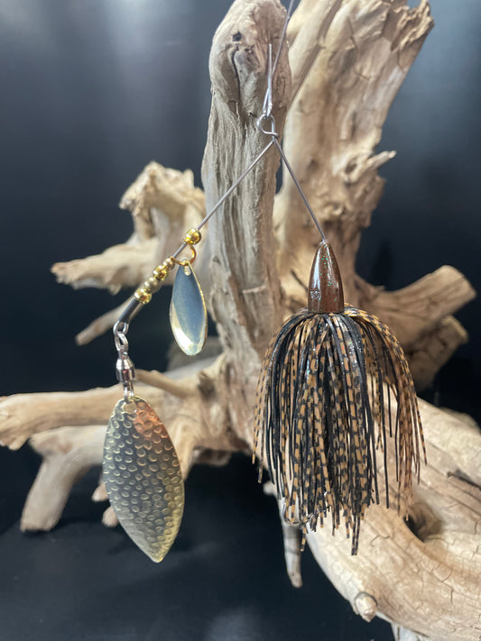 A black and brown Bass designed spinnerbait fishing lure, weighing 3/8 oz. Equipped with a #5 Willow blade and #4/0 hook, it's sure to attract a wide range of fish. Don't miss out on this must-have addition to your fishing gear.