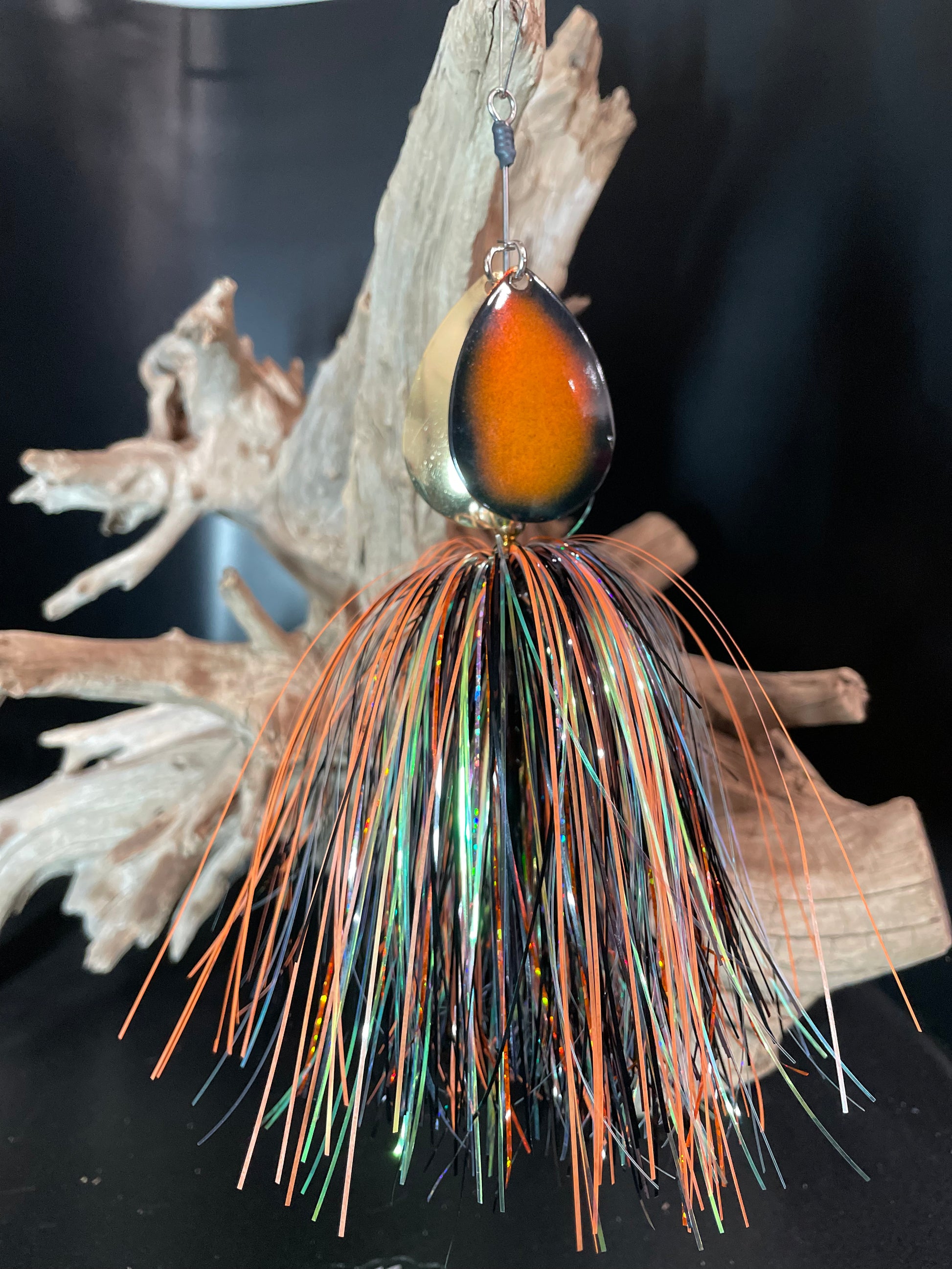 Muskie Bucktail Fishing lure with orange, black, and silver skirt. 2 x #8 blades, one orange and black and one Gold