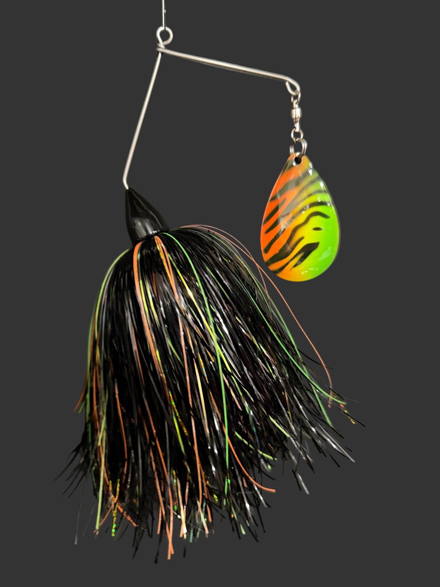 Fishing lure with black and orange pattern on a dark background