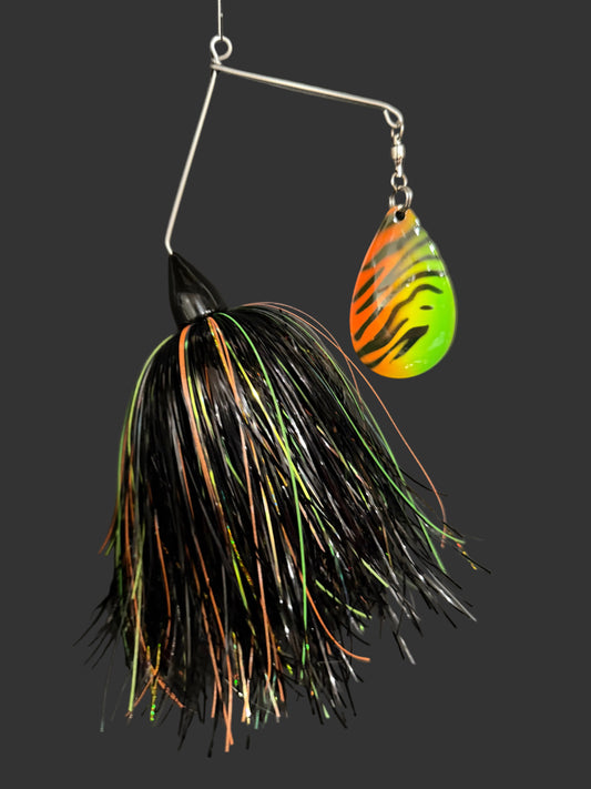 Fishing lure with black and orange pattern on a dark background