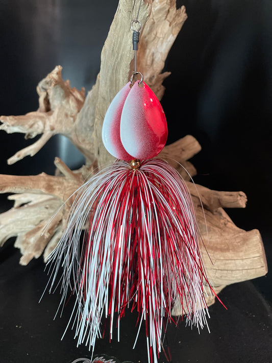 Fishing lure with red and white details on a dark background