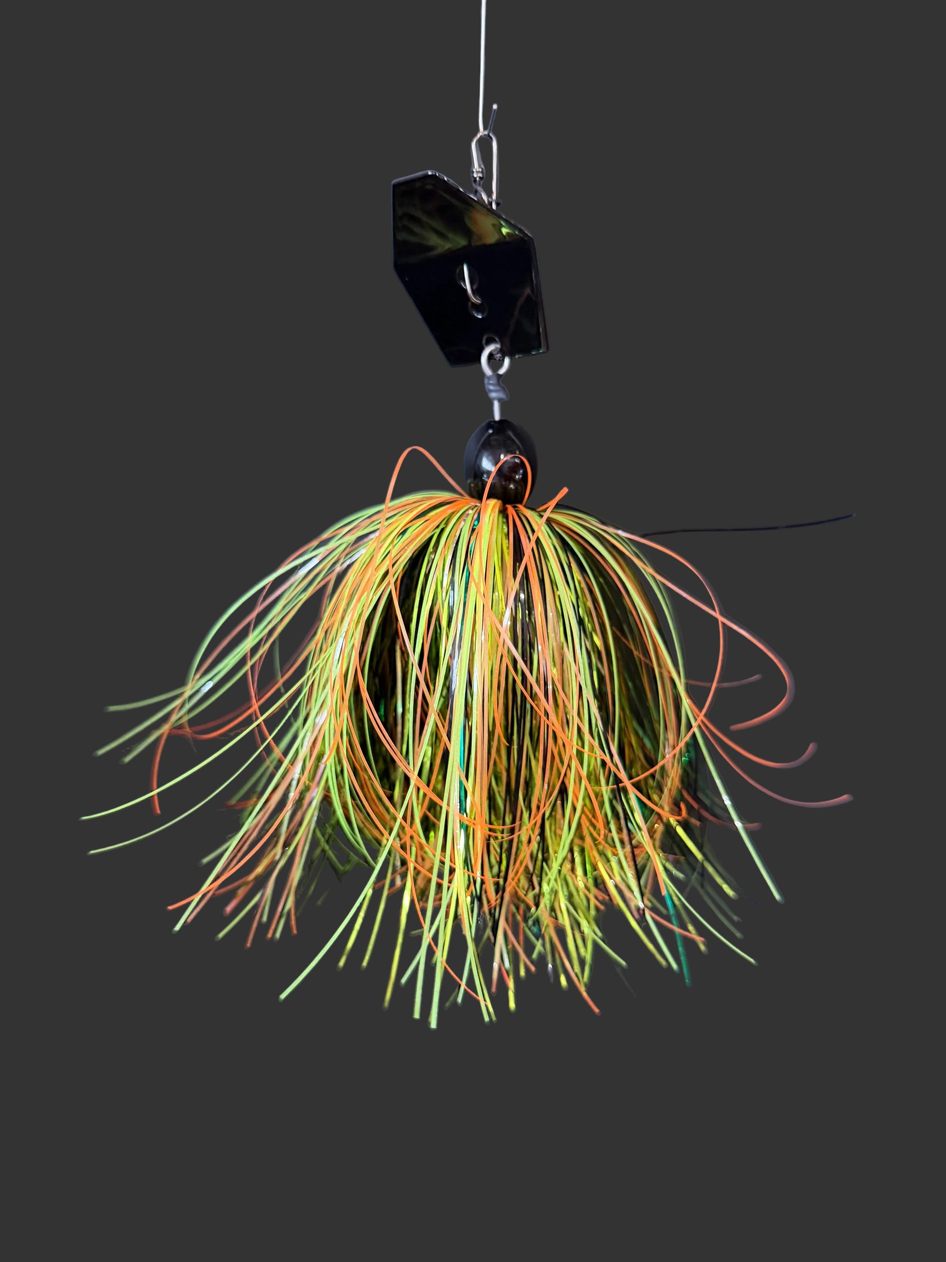 Muskie chatterbait fishing lure with a black blade and a yellow, orange, light green, dark green, and black skirt. made by Lure-cifer in Brantford Ontario Canada