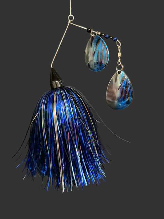 Blue and silver fishing lure on a gray background