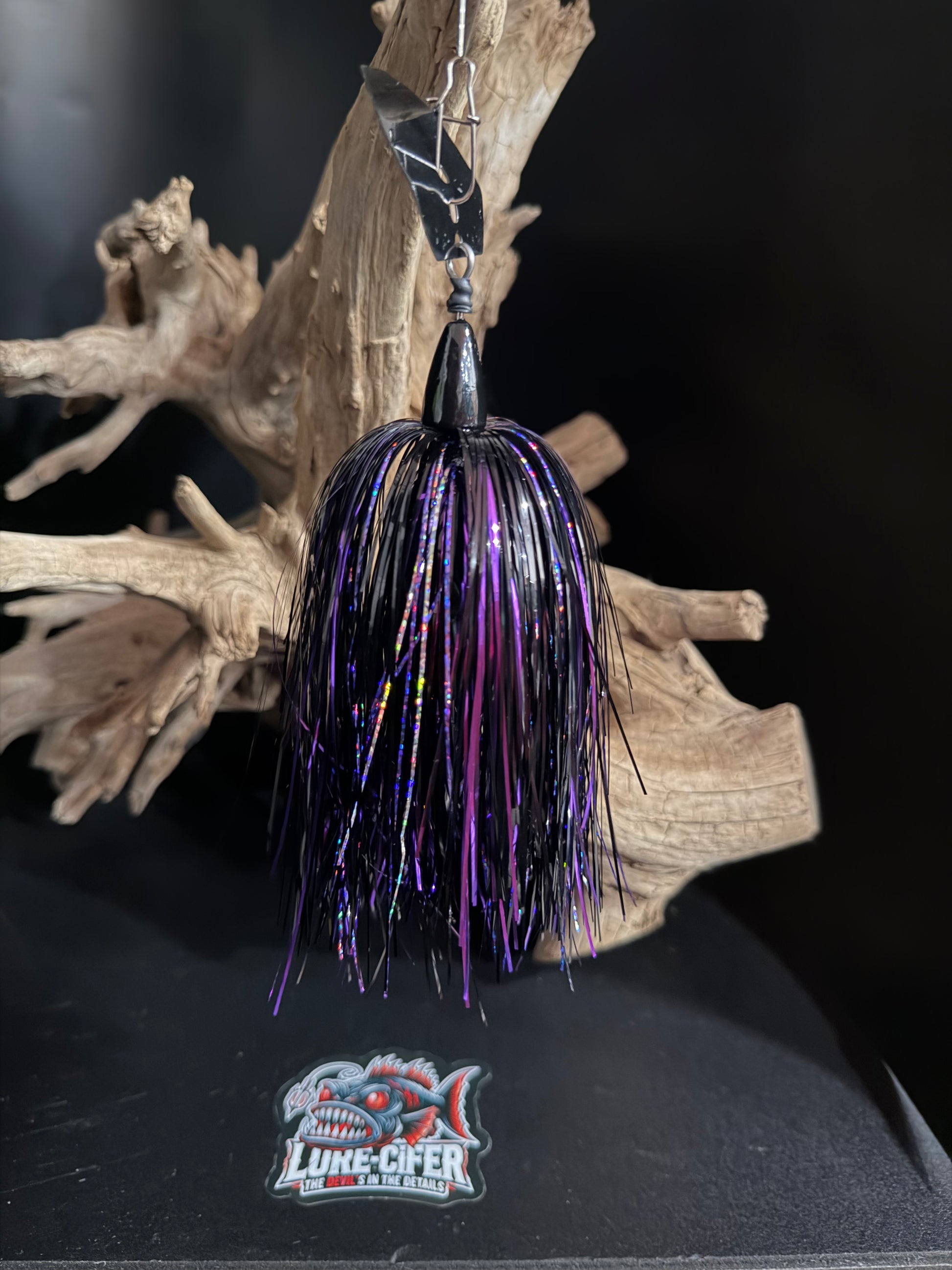 Fishing lure with purple and black details on a dark background