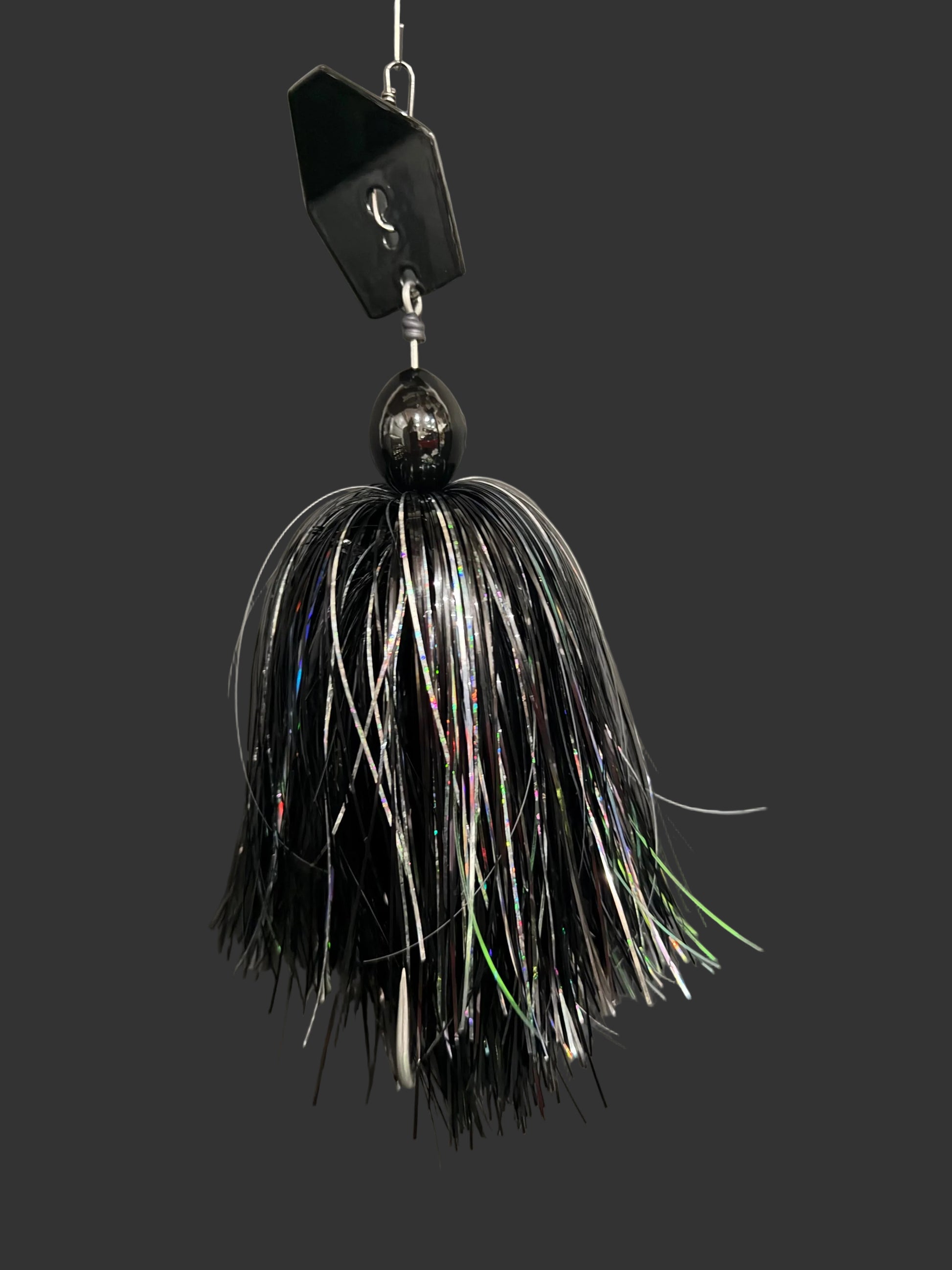 Black and white fishing lure on a gray background