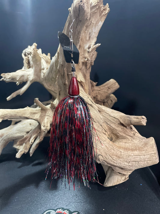 Discover the ultimate fishing experience with Vampire's Kiss, featuring a sleek Black and Red Muskie Chatterbait that guarantees a productive catch. Enjoy the power and precision of its 1 oz head and #7/0 hook, perfect for catching the biggest fish. Upgrade your fishing game now.