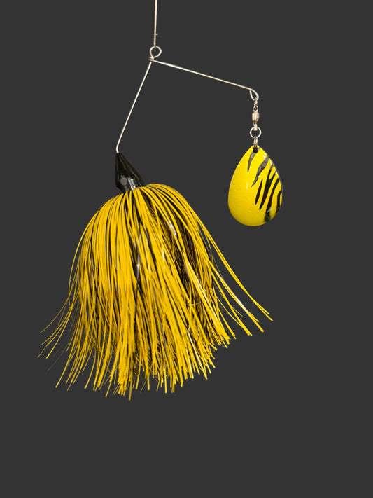 Yellow and black fishing lure on a gray background