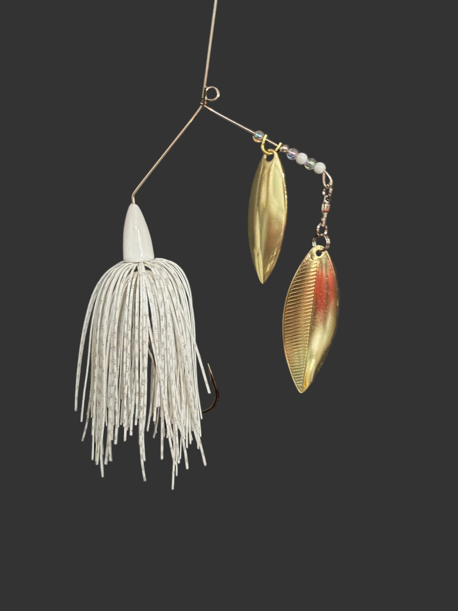 A Bass Spinnerbait fishing lure with a white skirt and dual gold willow blades