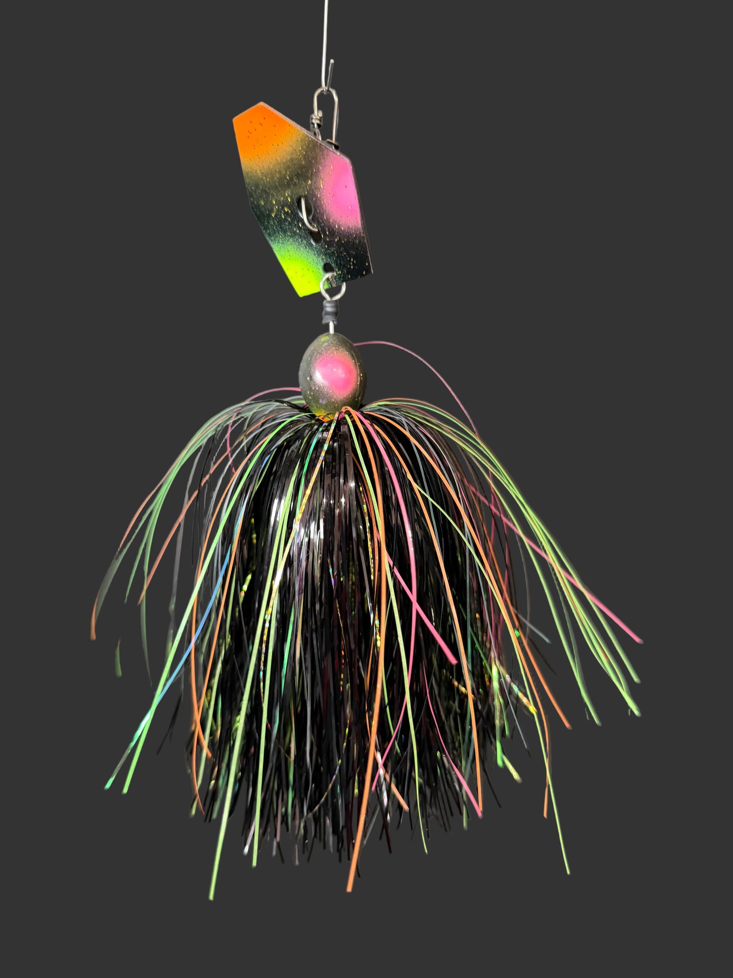 Muskie chatterbait with a black, orange, pink and chartreuse blade and skirt. made by Lure-cifer in Brantford, Ontario, Canada