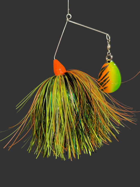 Fishing lure with green and orange details on a dark background