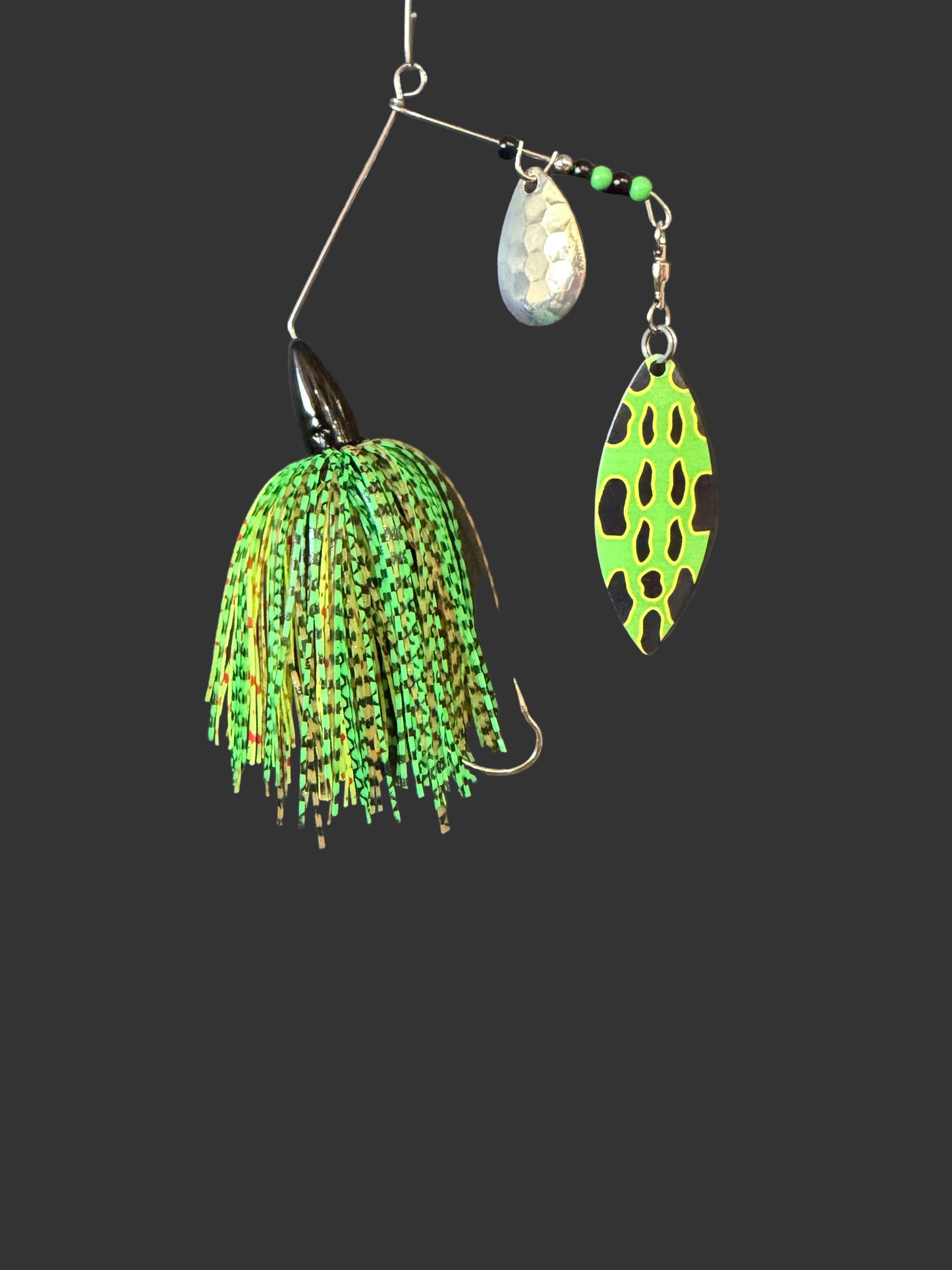 A 3/8 oz Bass Spinnerbait fishing lure featuring a #4/0 hook, #5 Willow Blade, and deep cut Colorado blade. Catch more fish with this green and black lure designed for optimal performance.