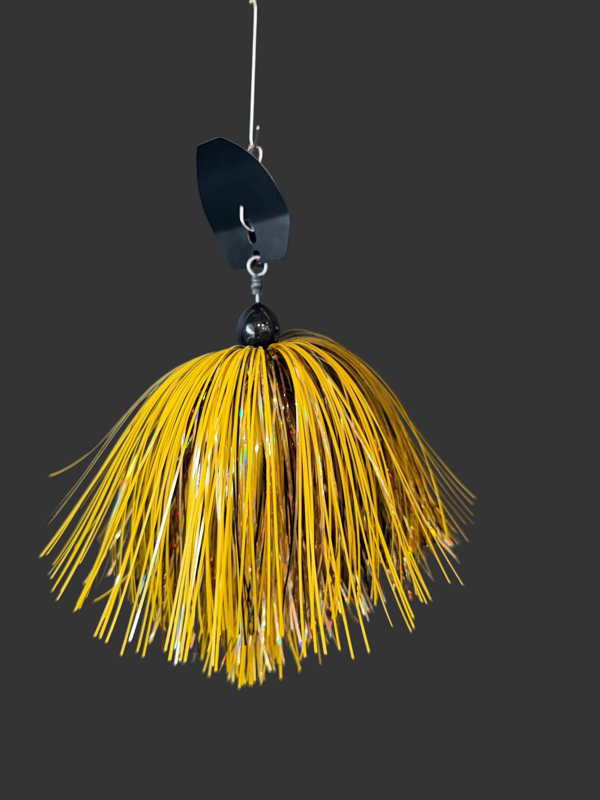 Muskie Chatterbait with a black blade and a yellow and bronze skirt, available in sizes 1oz-3oz made by Lure-Cifer in Brantford, Ontario Canada.